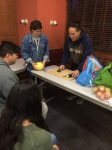 a student cutting a cucumber